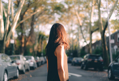 Side view of woman standing on road