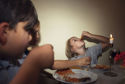 Children at table eating pizza