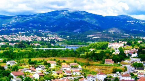 Townscape by mountains against sky