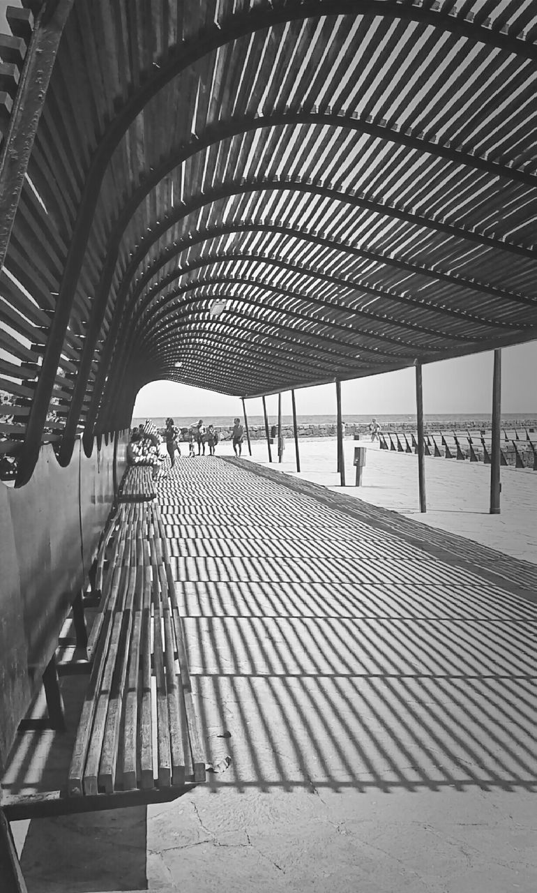 the way forward, railing, built structure, architecture, diminishing perspective, indoors, sunlight, steps, shadow, empty, vanishing point, high angle view, metal, steps and staircases, transportation, incidental people, day, pattern, staircase, absence