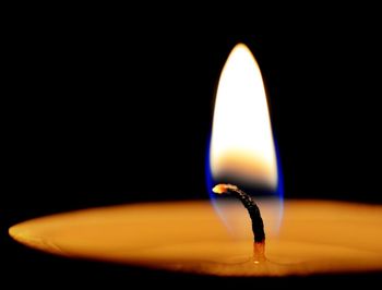 Close-up of illuminated lamp against black background