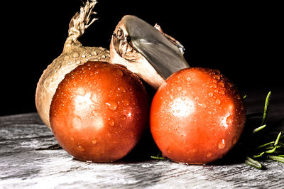 Close-up of oranges on table against black background