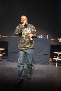 Full length portrait of man standing on table