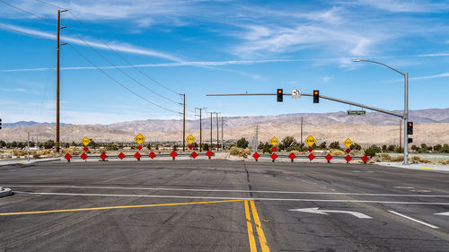 Road by street against sky