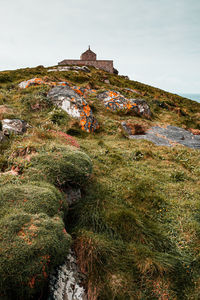Low angle view of built structure on land against sky
