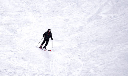 Full length of senior woman in snow