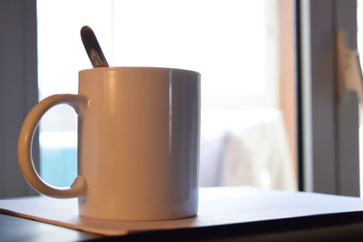 Close-up of coffee cup on table