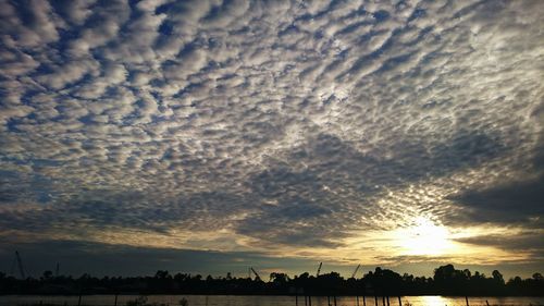 Scenic view of calm sea against cloudy sky