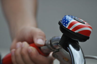 Cropped hand holding bicycle