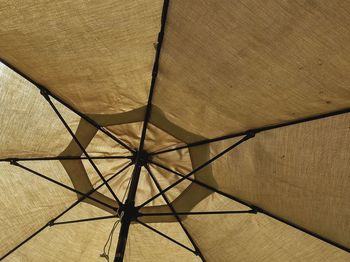 Low angle view of beige umbrella