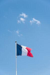 Low angle view of flag against blue sky. low angle view of french flag. the flag of france