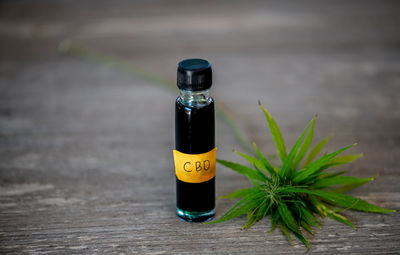 Close-up of yellow bottle on table