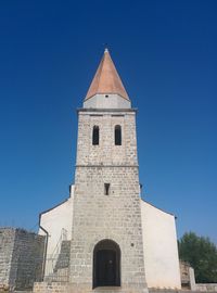 Low angle view of building against clear blue sky