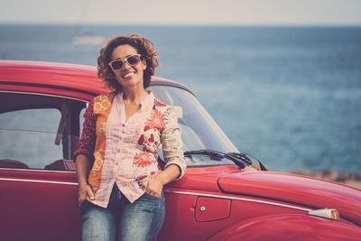 Full length of a smiling young woman in car