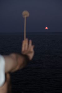 Cropped hand of man holding illuminated light