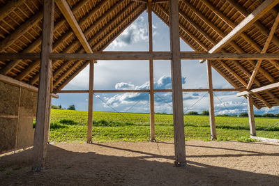 Barn on field against sky