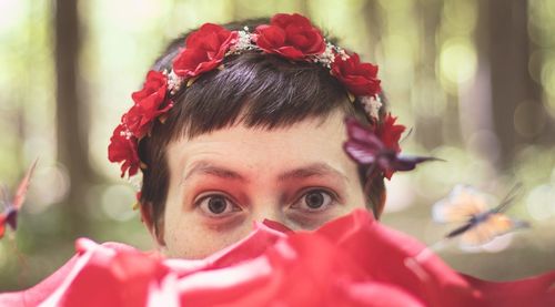 Close-up portrait of woman with red flower