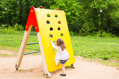 Full length of girl playing on playground