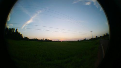 Scenic view of field against sky during sunset