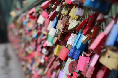 Close-up of padlocks hanging on railing
