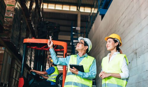 Low angle view of engineers doing inspection at factory