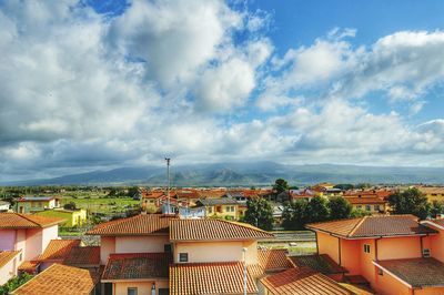 Cityscape against cloudy sky