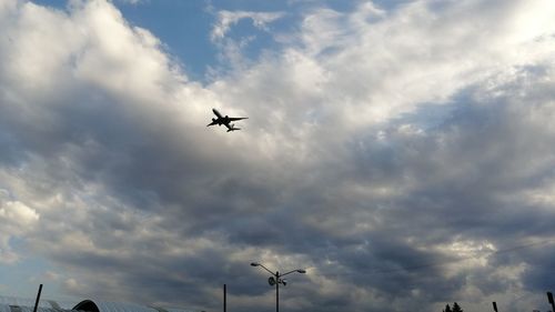 Low angle view of airplane flying in sky