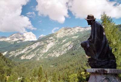 Side view of statue against mountain