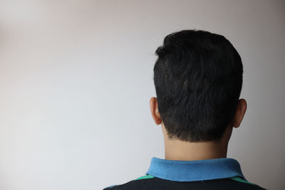 Rear view of man against white background