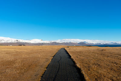 Scenic view of landscape against blue sky