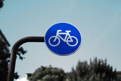 Low angle view of bicycle lane signboard against clear sky