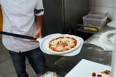 Midsection of man preparing food