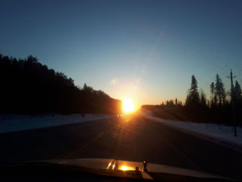 Car on road against sky during sunset