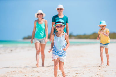 Friends standing at beach