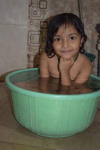 Portrait of smiling boy sitting in bathtub