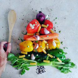 Cropped hand of man arranged food on table