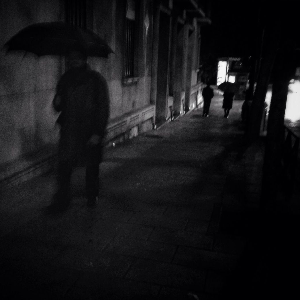 walking, men, full length, architecture, lifestyles, built structure, rear view, indoors, silhouette, the way forward, person, leisure activity, building exterior, city life, shadow, street, night