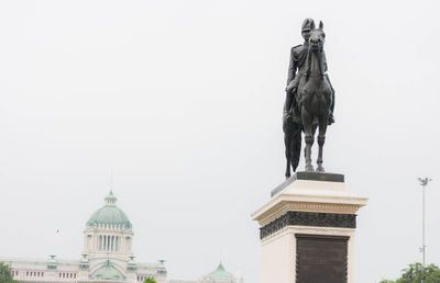 Low angle view of statue of building against clear sky