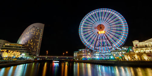 Low angle view of ferris wheel at night