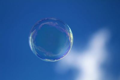 Close-up of bubbles against rainbow in sky