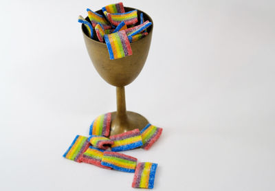 Close-up of candies on table against white background