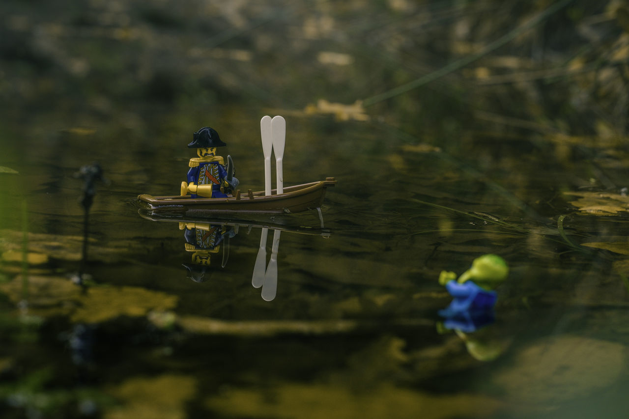 water, nautical vessel, lake, reflection, mode of transport, nature, transportation, outdoors, grass, no people, day, beauty in nature