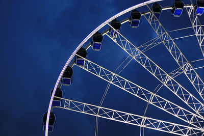 Low angle view of ferris wheel against blue sky