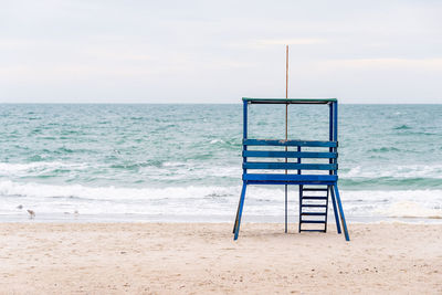 Lifeguard hut on beach against sky