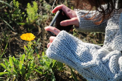 Midsection of woman using mobile phone