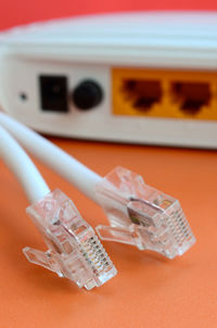 Close-up of computer cables and router on table