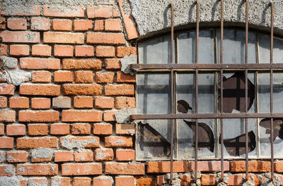 Low angle view of window on brick wall of building