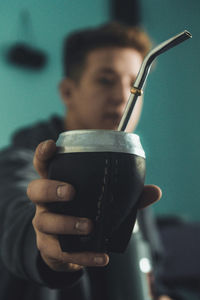 Close-up portrait of boy holding drink