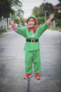 Asian children wearing red and green suit of santa claus theme standing outdoor