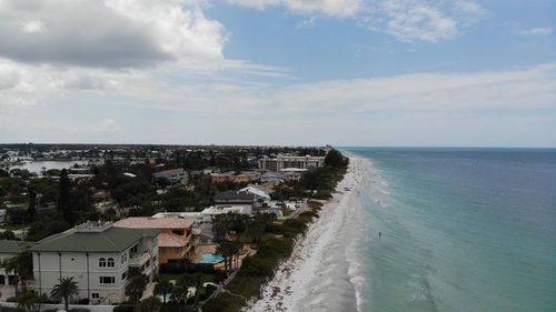 High angle view of sea and buildings against sky